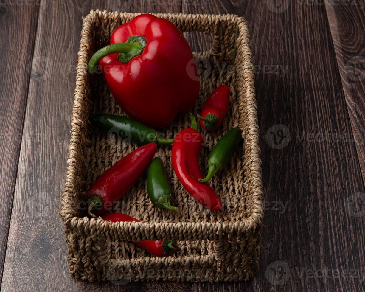 Pepper and chillies in a basket photo