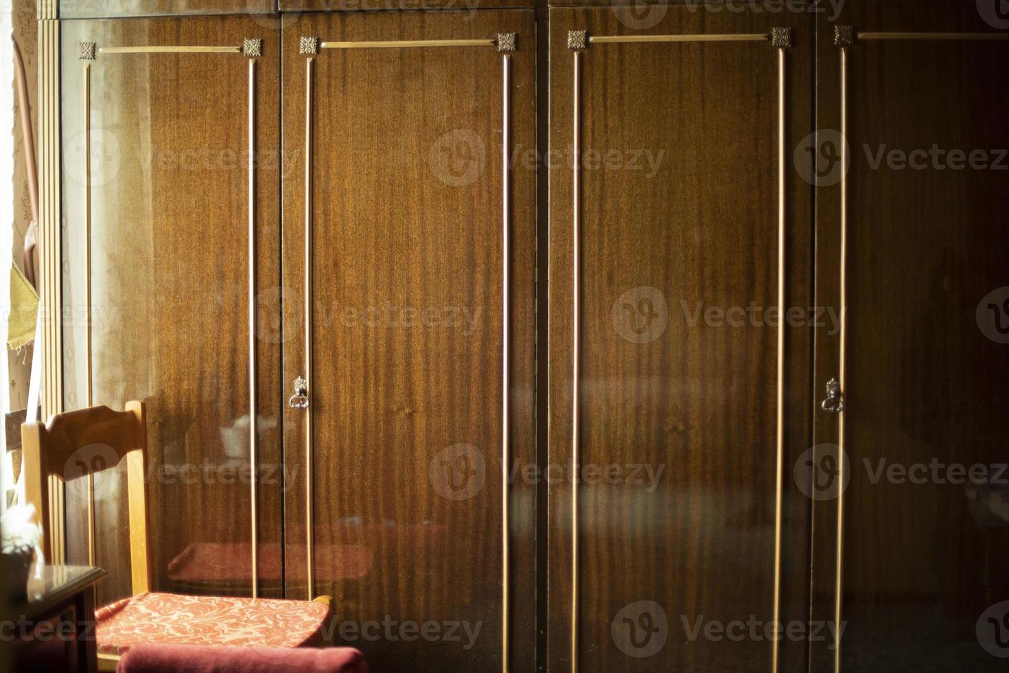 Old wardrobe in apartment. Old furniture in interior. photo