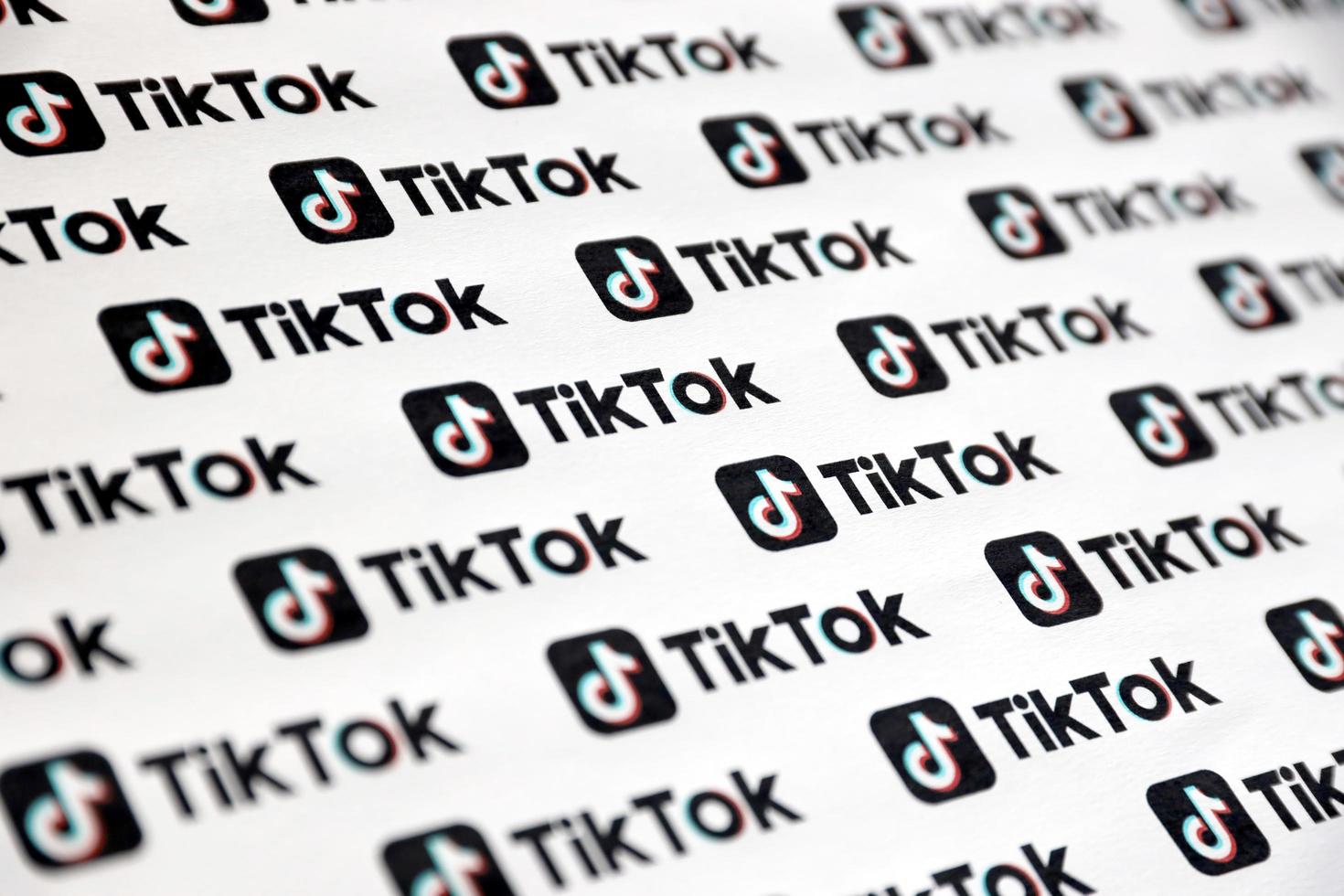 Ternopil, Ukraine - May 8, 2022 Many TikTok logo printed on paper. Tiktok or Douyin is a famous Chinese short-form video hosting service owned by ByteDance photo