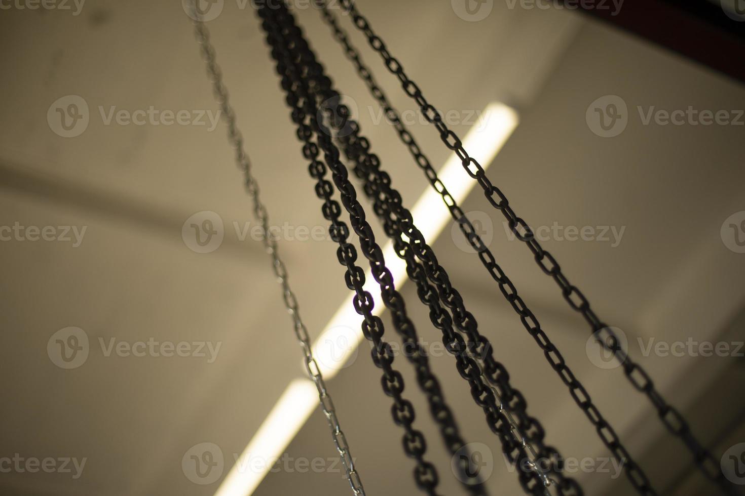 Chain on ceiling. Chains hang on steel beam. photo