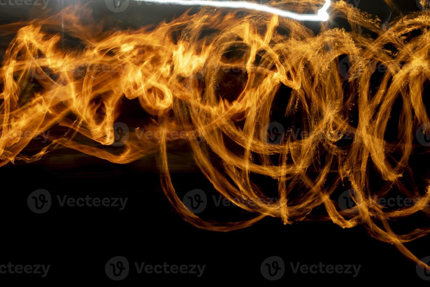 Circles of fire. Lines of flame. Shooting fire show on long shutter speed. photo