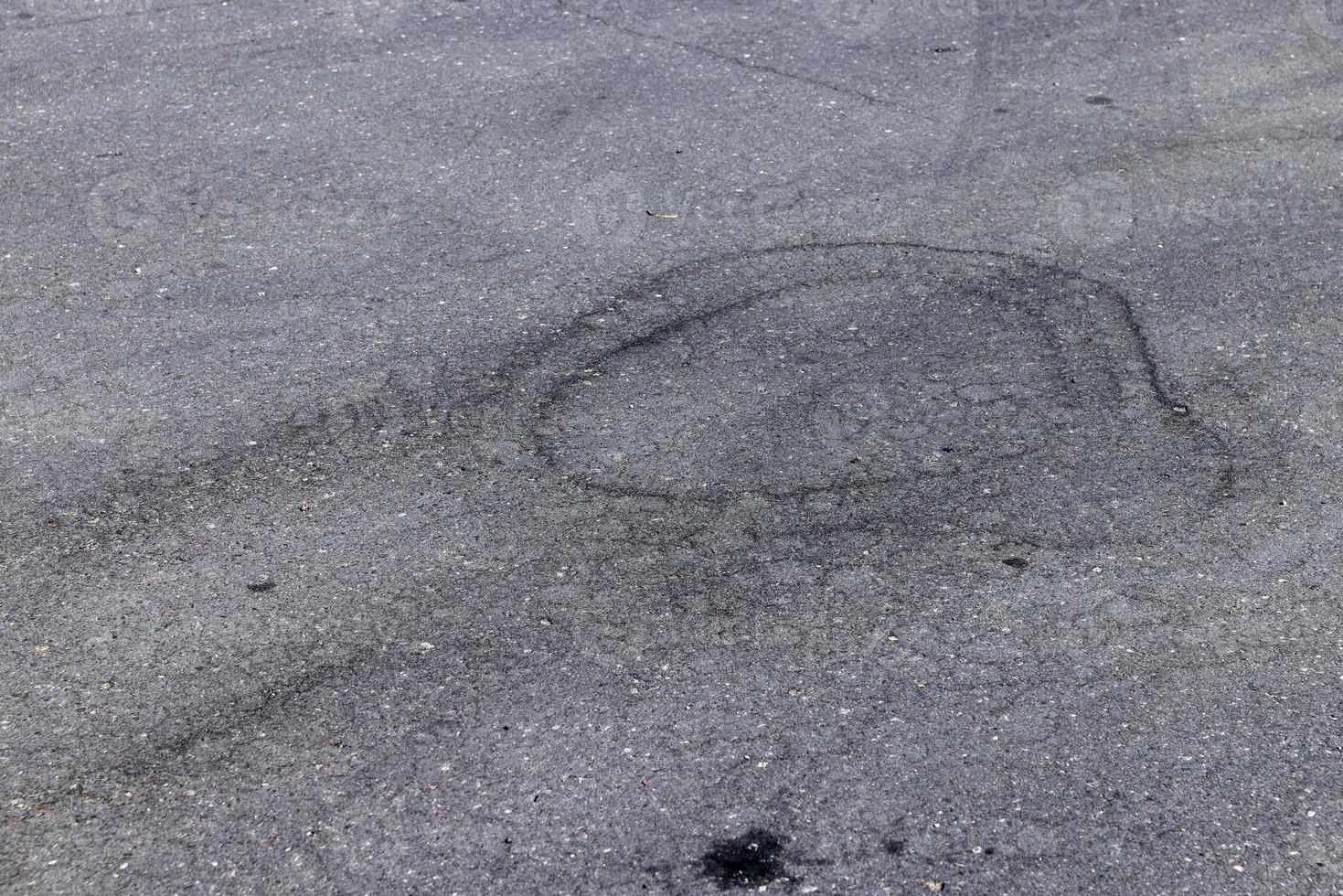 part of the paved road is blocked with waste from cars photo