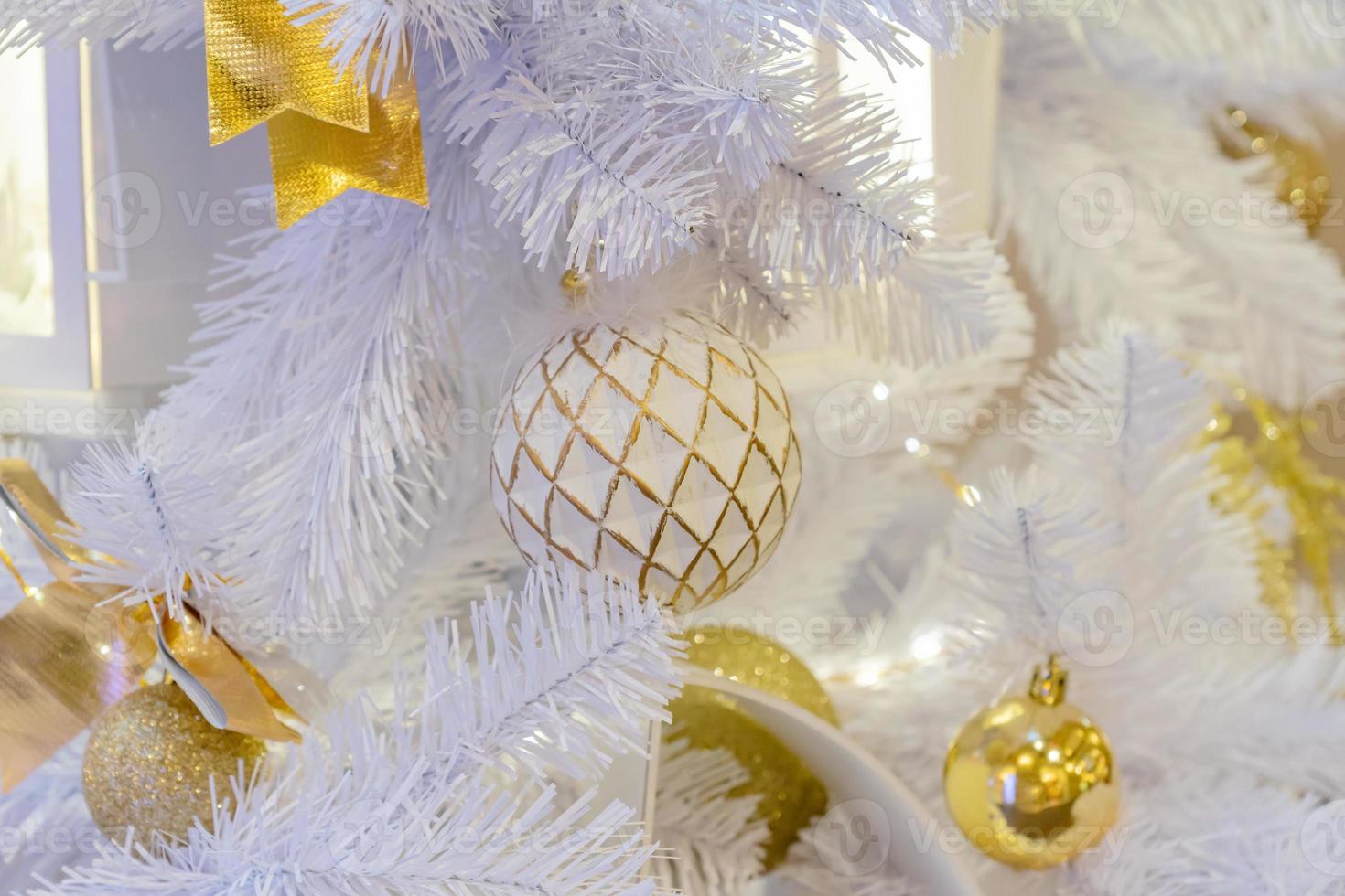 close up of christmas tree decorated with sparkling balls and garland with lights on. Festive background with copy space for your projects photo