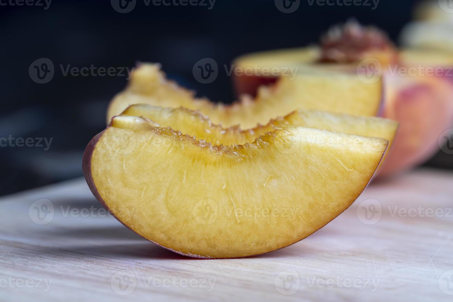 Ripe fresh peaches on a wooden table photo