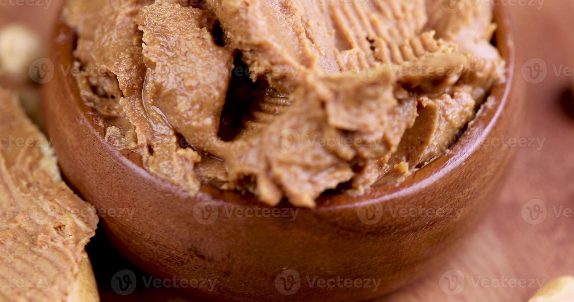 peanut butter with chunks of crushed peanuts and whole peanuts photo