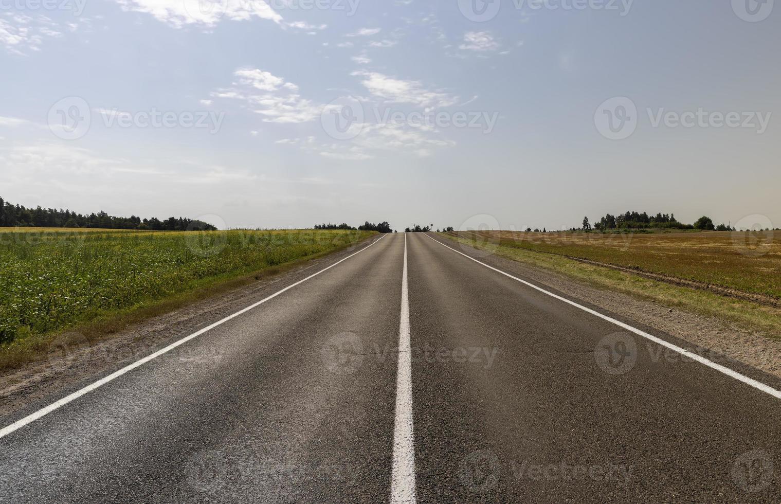 Narrow paved road for cars photo