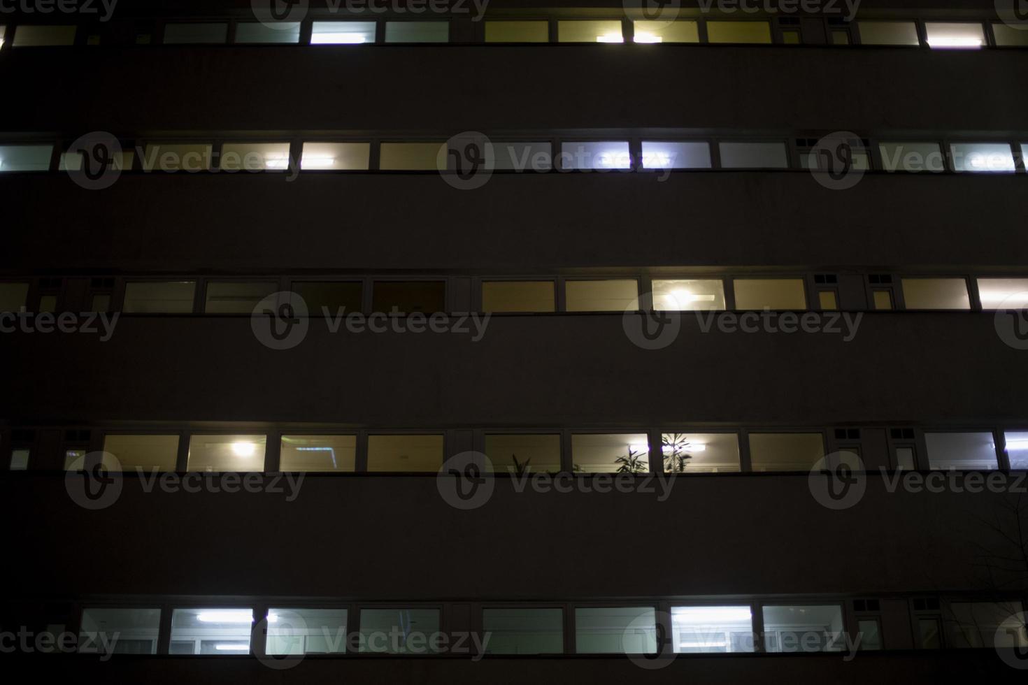 Windows in building at night. Unique architecture. photo