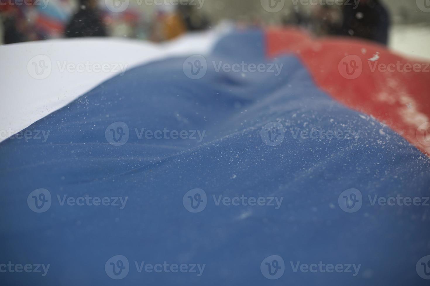 Flag of Russia in winter. Large cloth made of fabric. Symbol of state power in Russian Federation. photo