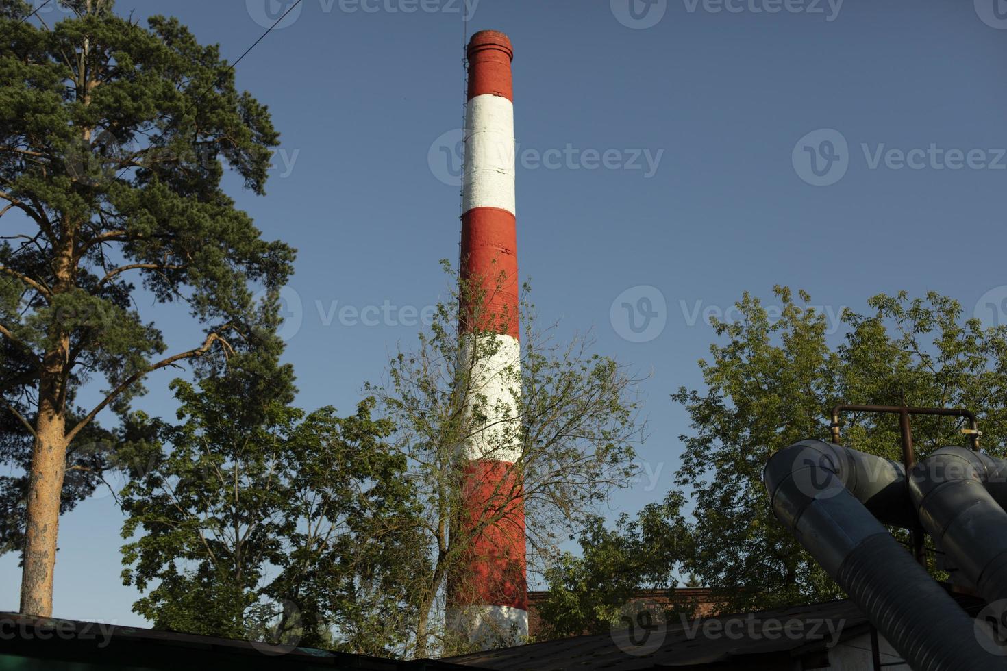 Red industrial pipe. Pipe factory. Details of industrial facility. photo