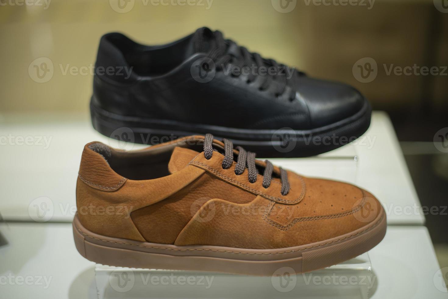 Shoes on counter. Sale of paints. Sneakers on podium. Shoe store window. photo