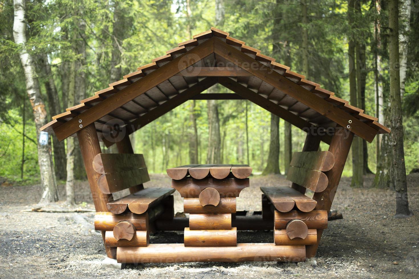 Cabin for relaxation in forest. Place for picnic in nature. Log structure. photo