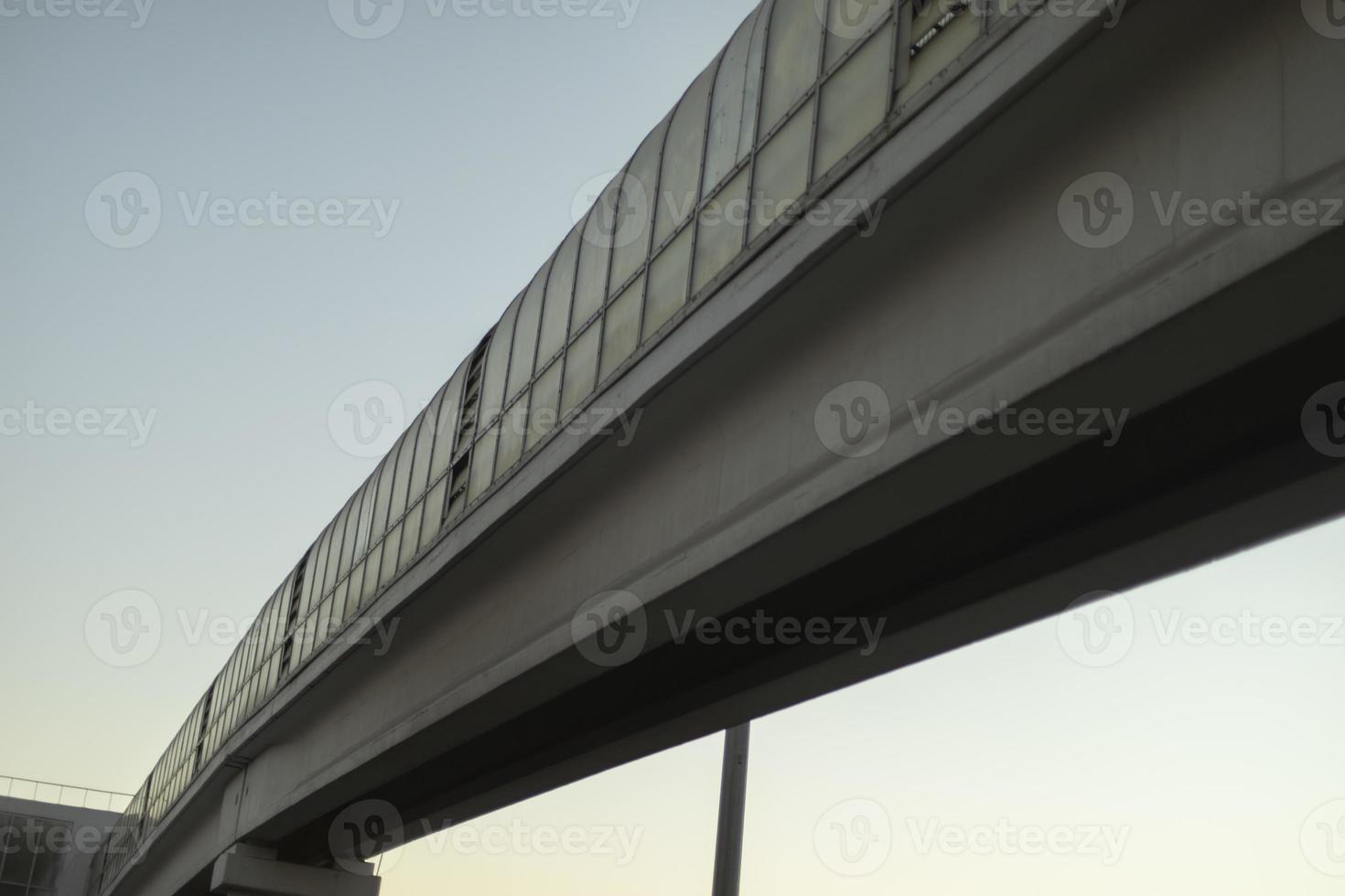 Long tunnel over road. Pedestrian crossing over highway. Details of urban infrastructure. photo