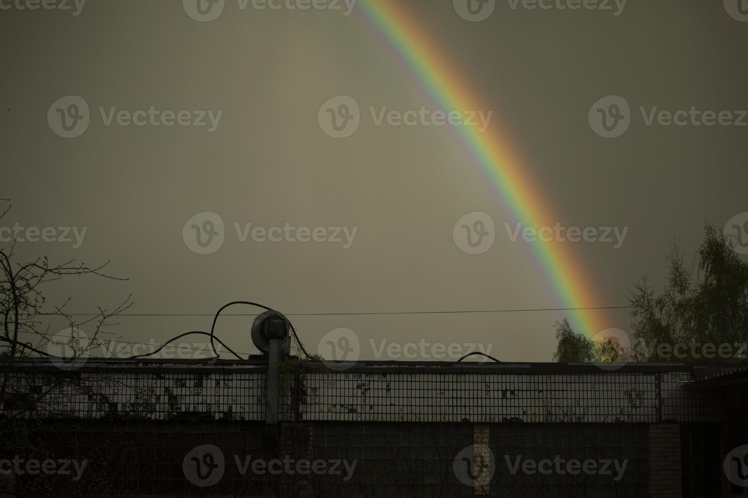 Rainbow in sky. Beautiful weather. Decomposition of light into colors. photo