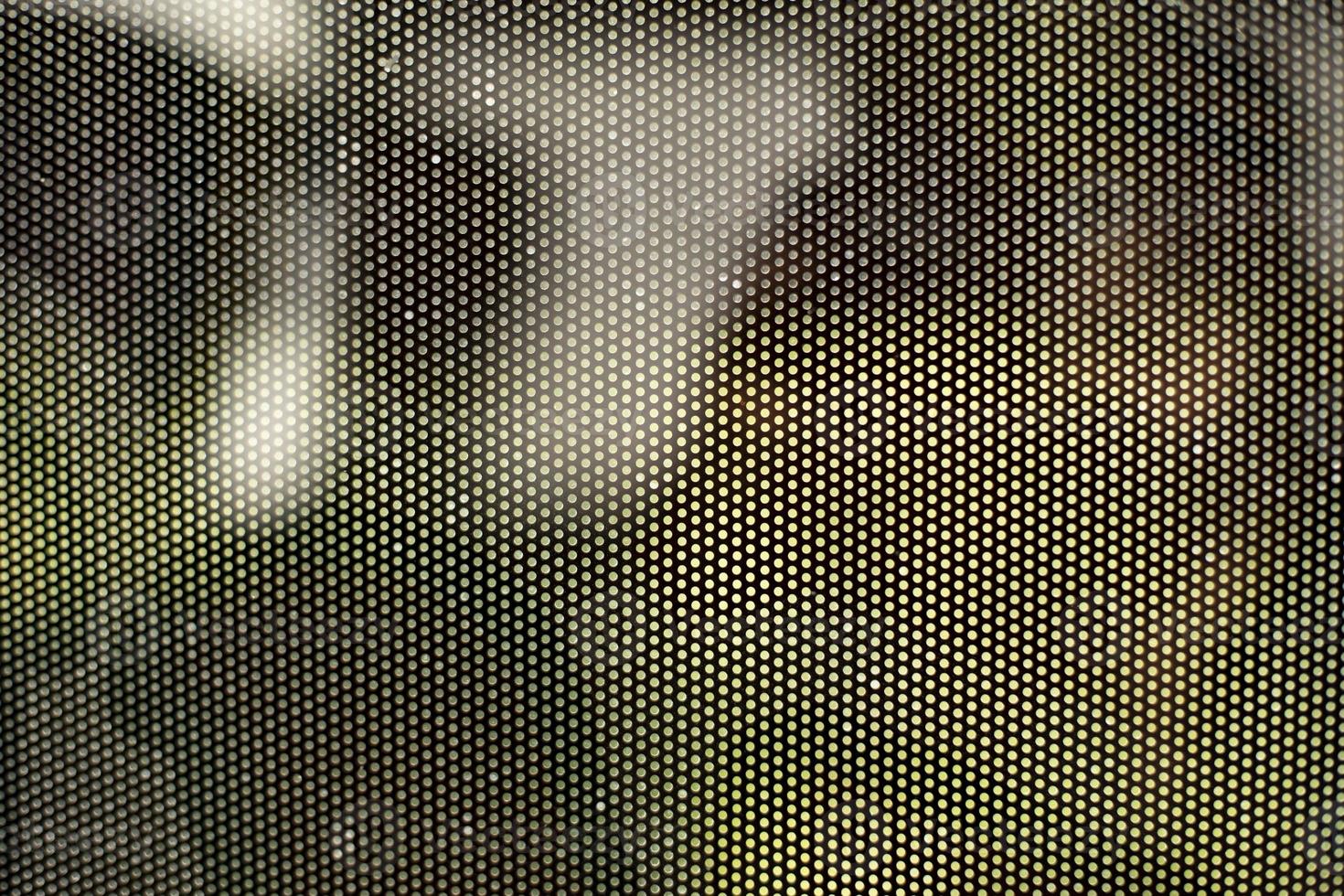 Mesh texture on glass. Shooting window. Small cage. photo