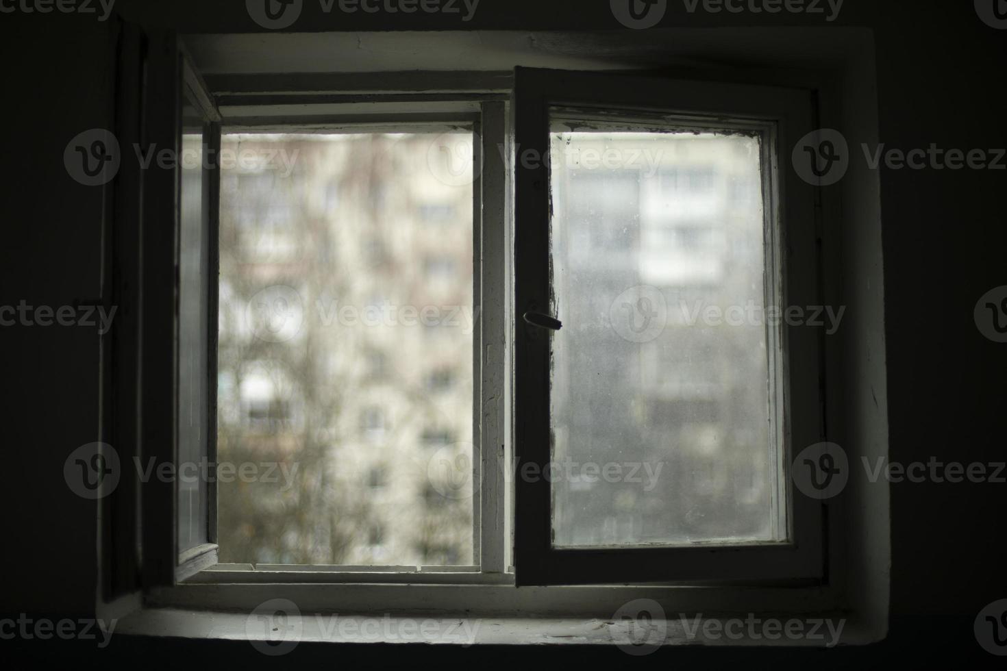Window to street. Window frame in dark. photo