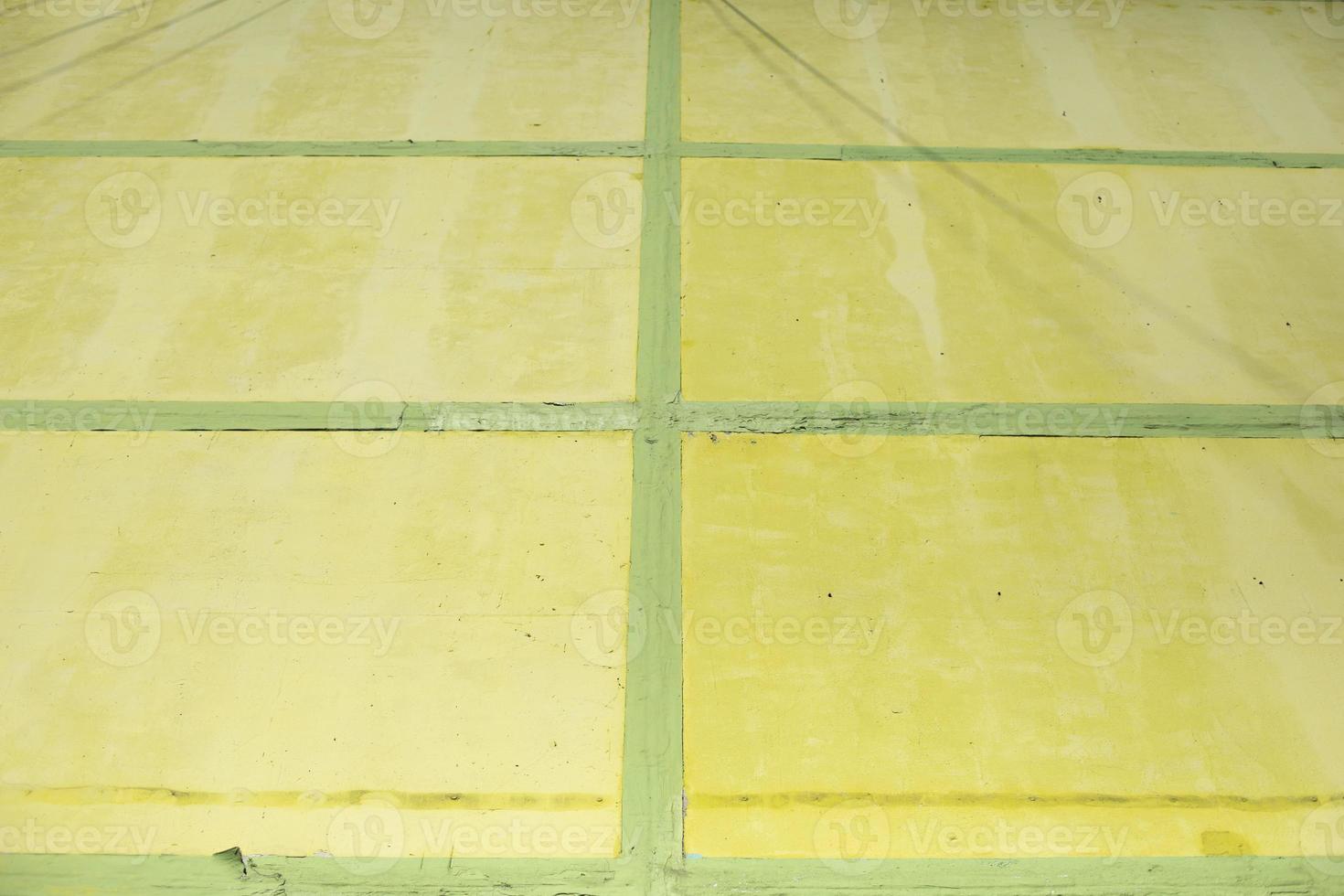 Yellow cells and green lines. Wall is painted. Structure is made of rectangles. photo