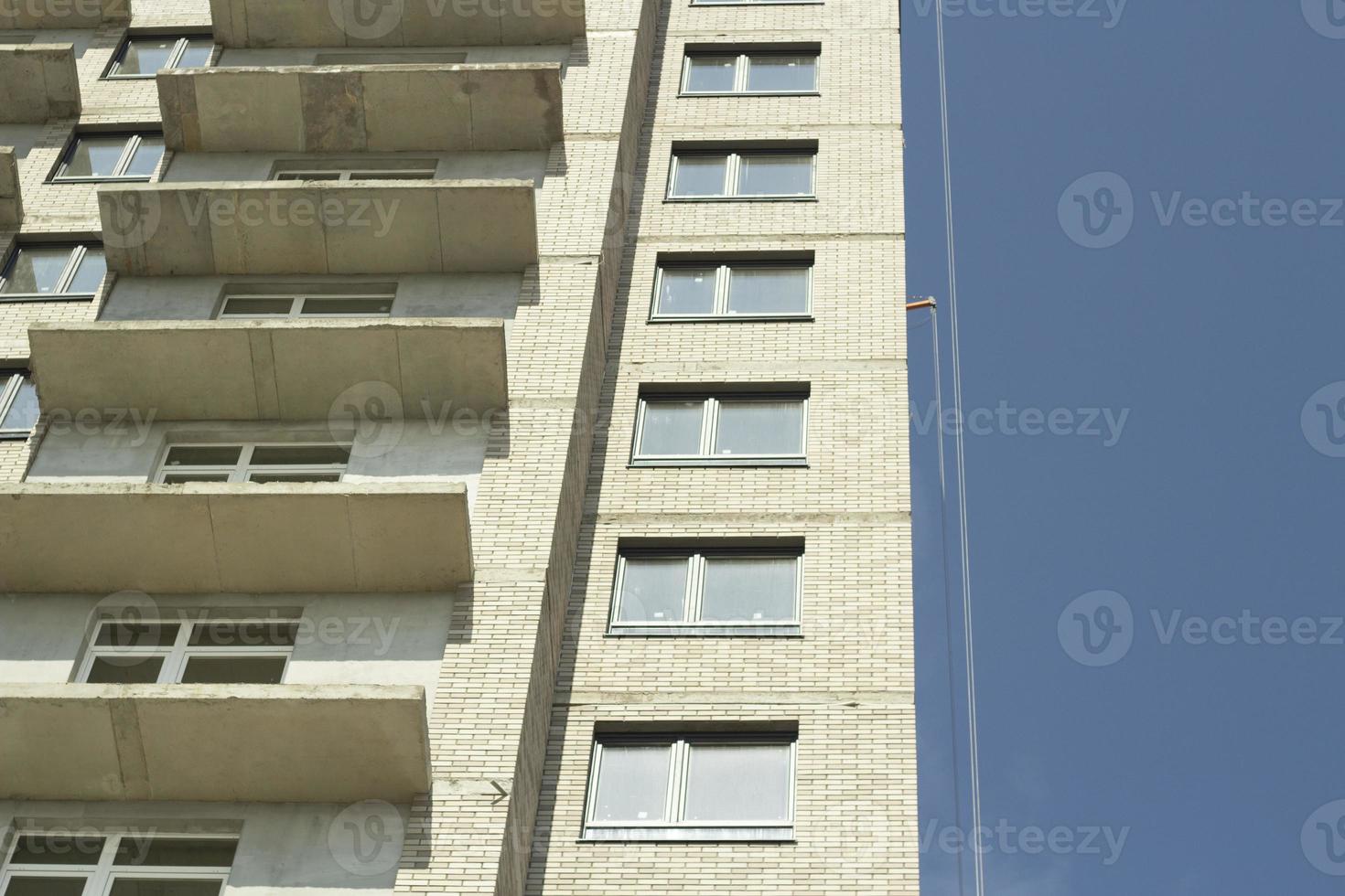 Windows in new house. Construction of residential complex. Building is made of concrete. Architecture details. photo