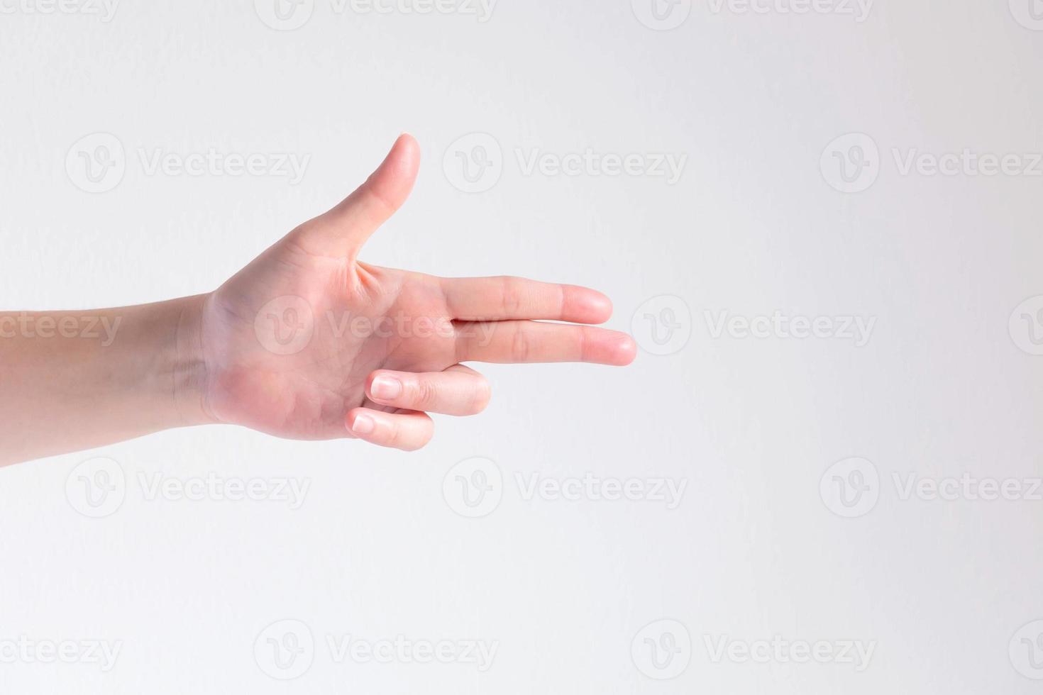 A hand pose to be gun shape on white background. photo