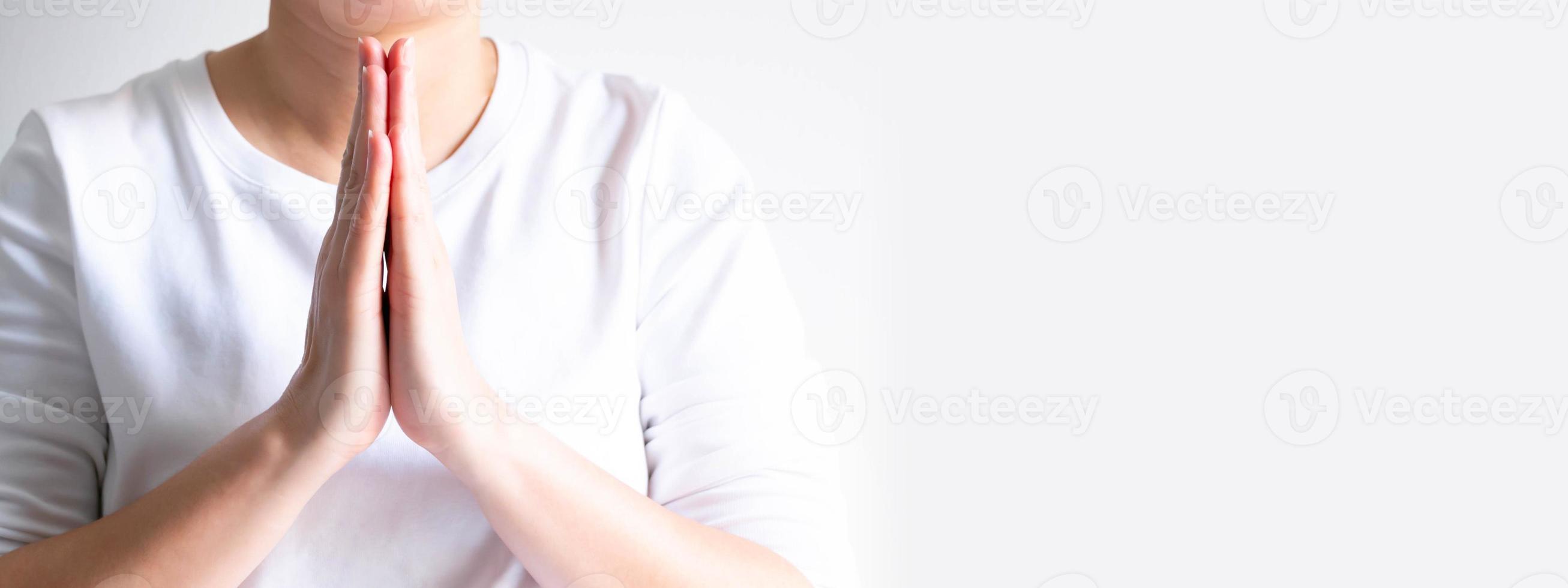 A close-up image of An Asian person hands paying respect, for saying hi, thanking, apologizing and farewell. photo