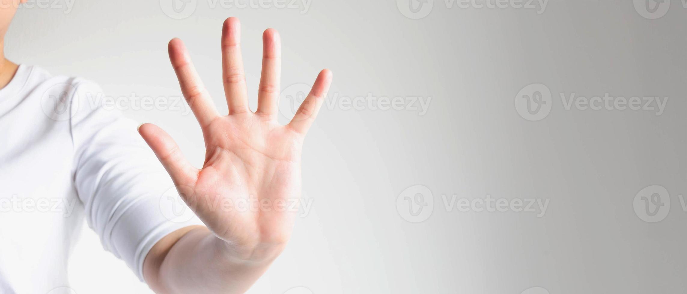 Close-up of a hand palm showing five fingers. The hand signs telling to stop and warning to do not do something. photo