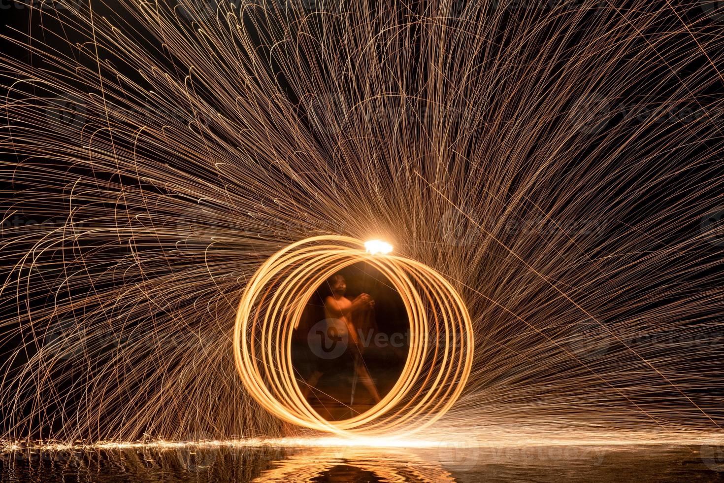 Fire dancers Swing fire dancing show fire show on the beach photo