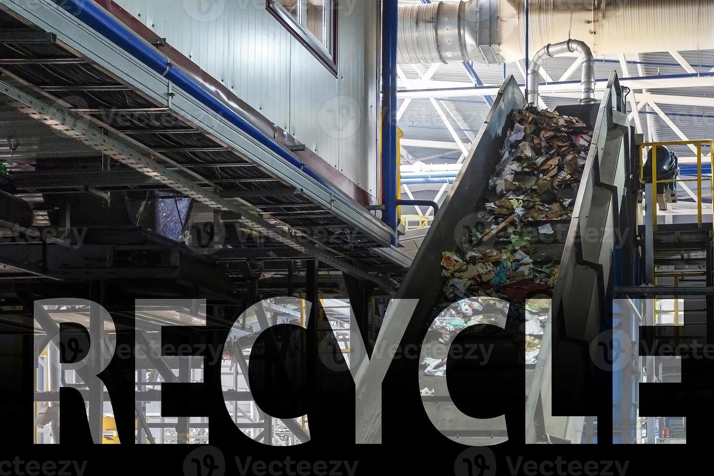 capital letters recycle on moving conveyor transporter on Modern waste recycling processing plant. Separate and sorting garbage collection. Recycling and storage of waste for further disposal. photo