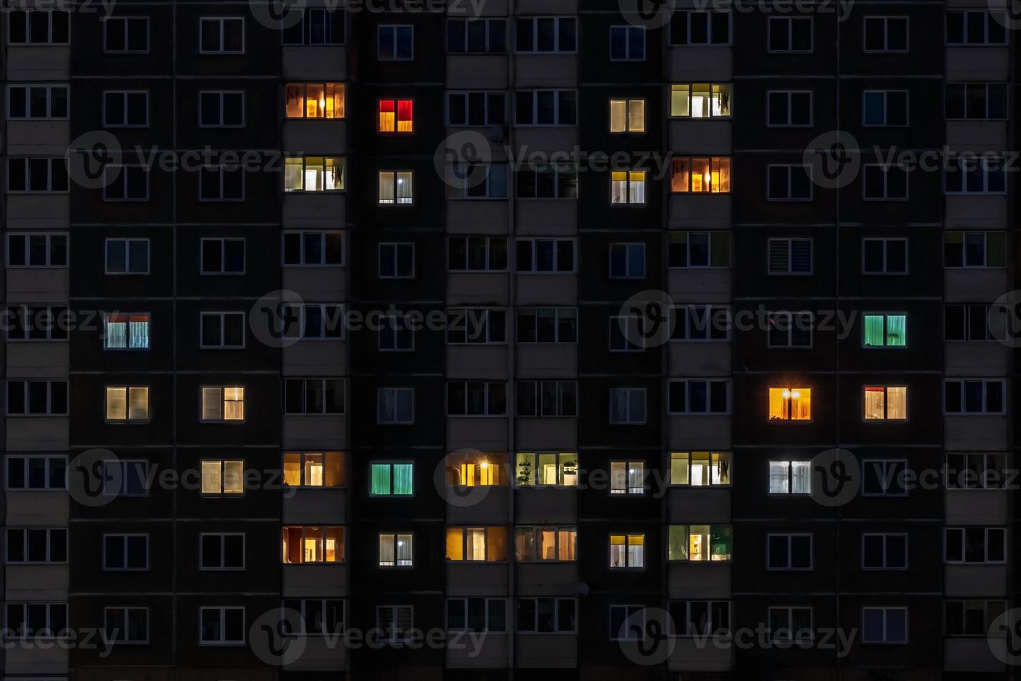 flat night panorama of multicolor smile face light in windows of multistory buildings photo