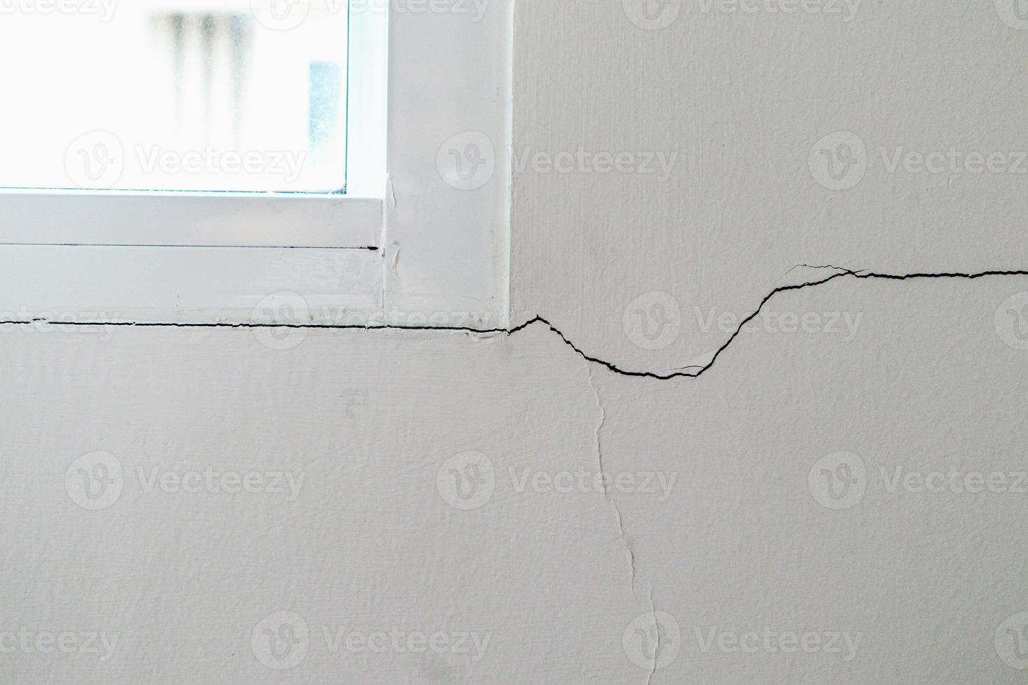 New house wall crack near window frame photo