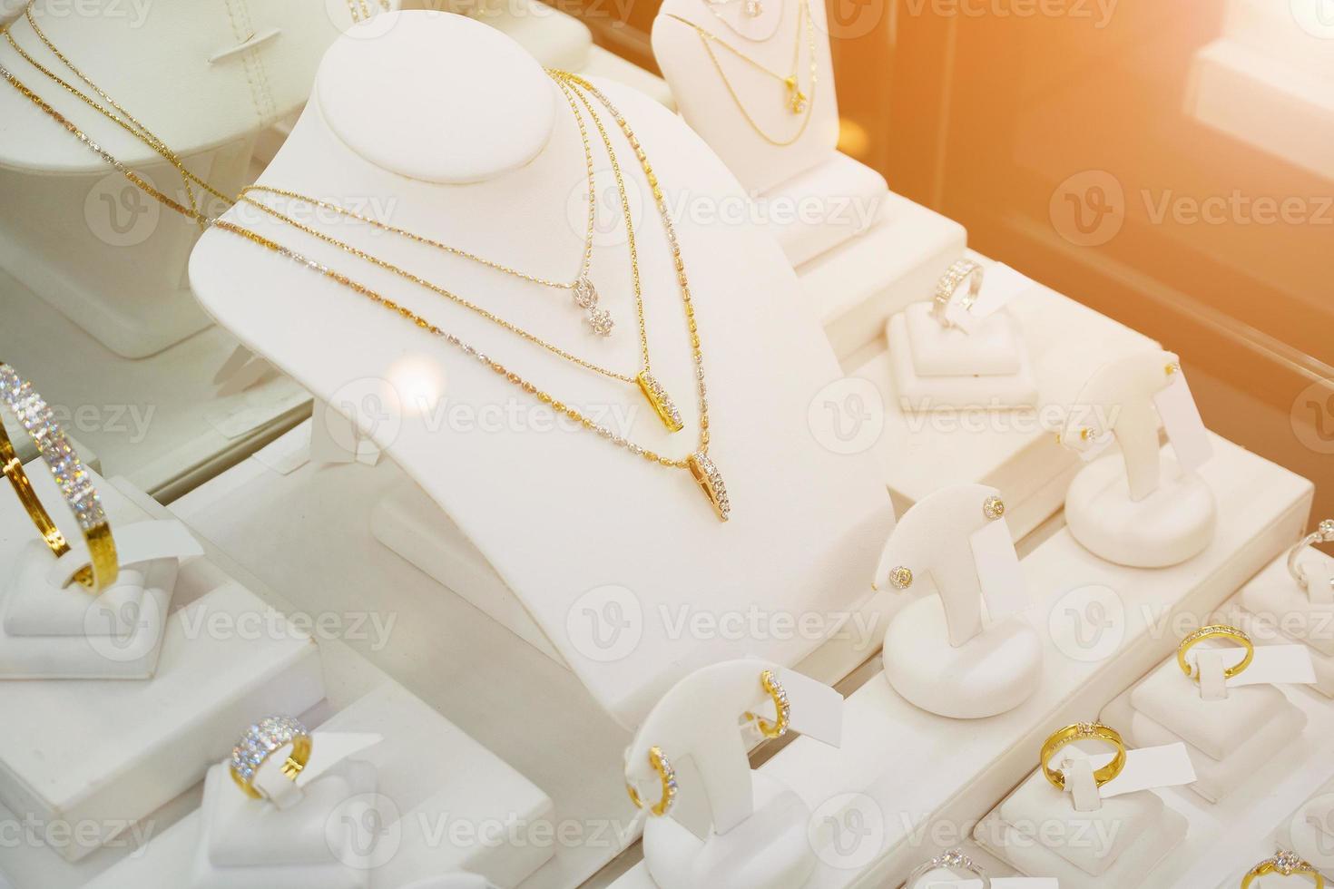 Jewelry diamond shop with rings and necklaces luxury retail store window display photo