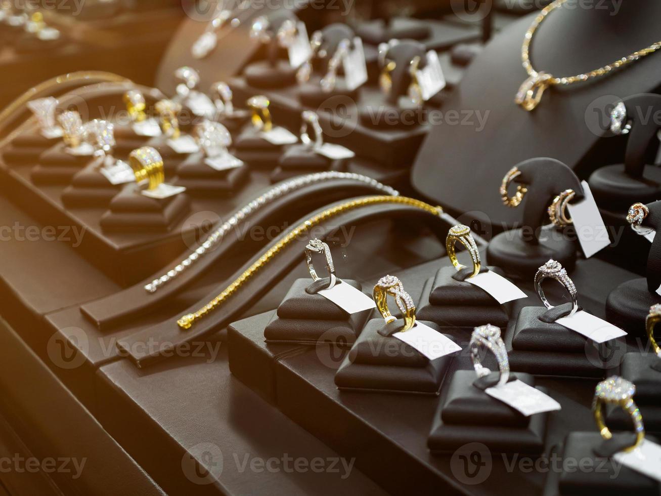 Gold jewelry diamond shop with rings and necklaces luxury retail store window display photo