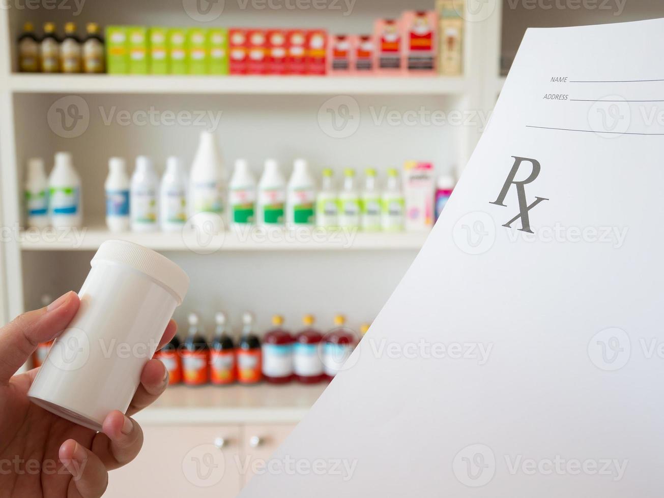 female pharmacist with prescription and medicine at the pharmacy photo