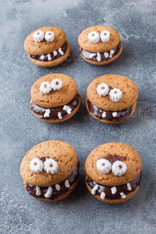 Cookies with chocolate paste in the form of monsters for Halloween photo