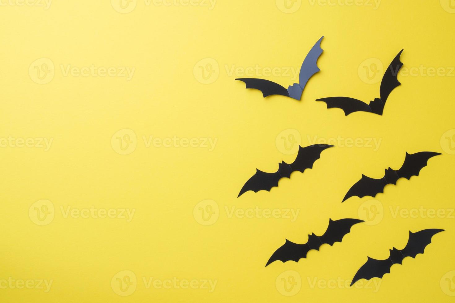 Scenery bats on a yellow background. Concept Halloween. photo