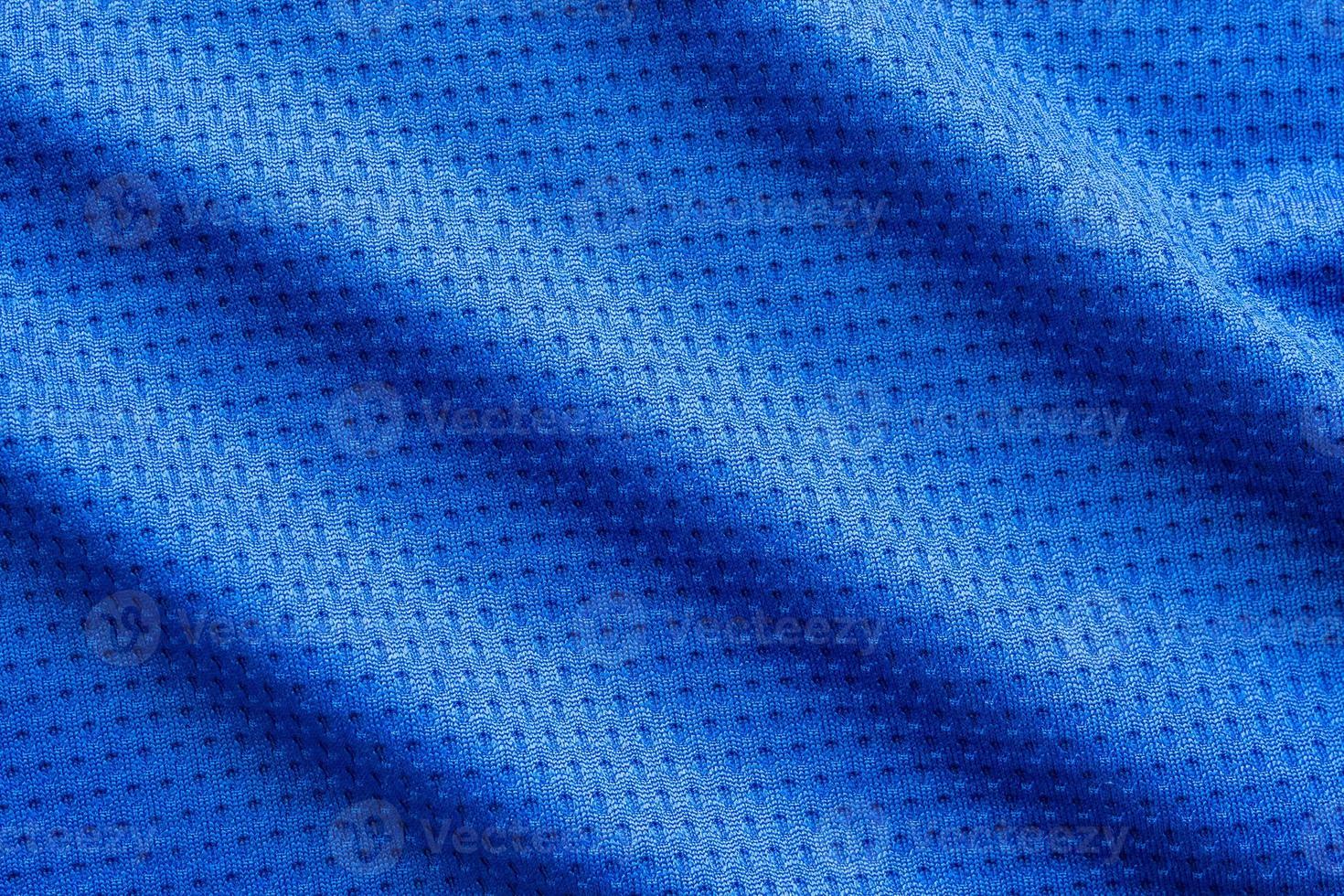 Blue color fabric sport clothing football jersey with air mesh texture background photo