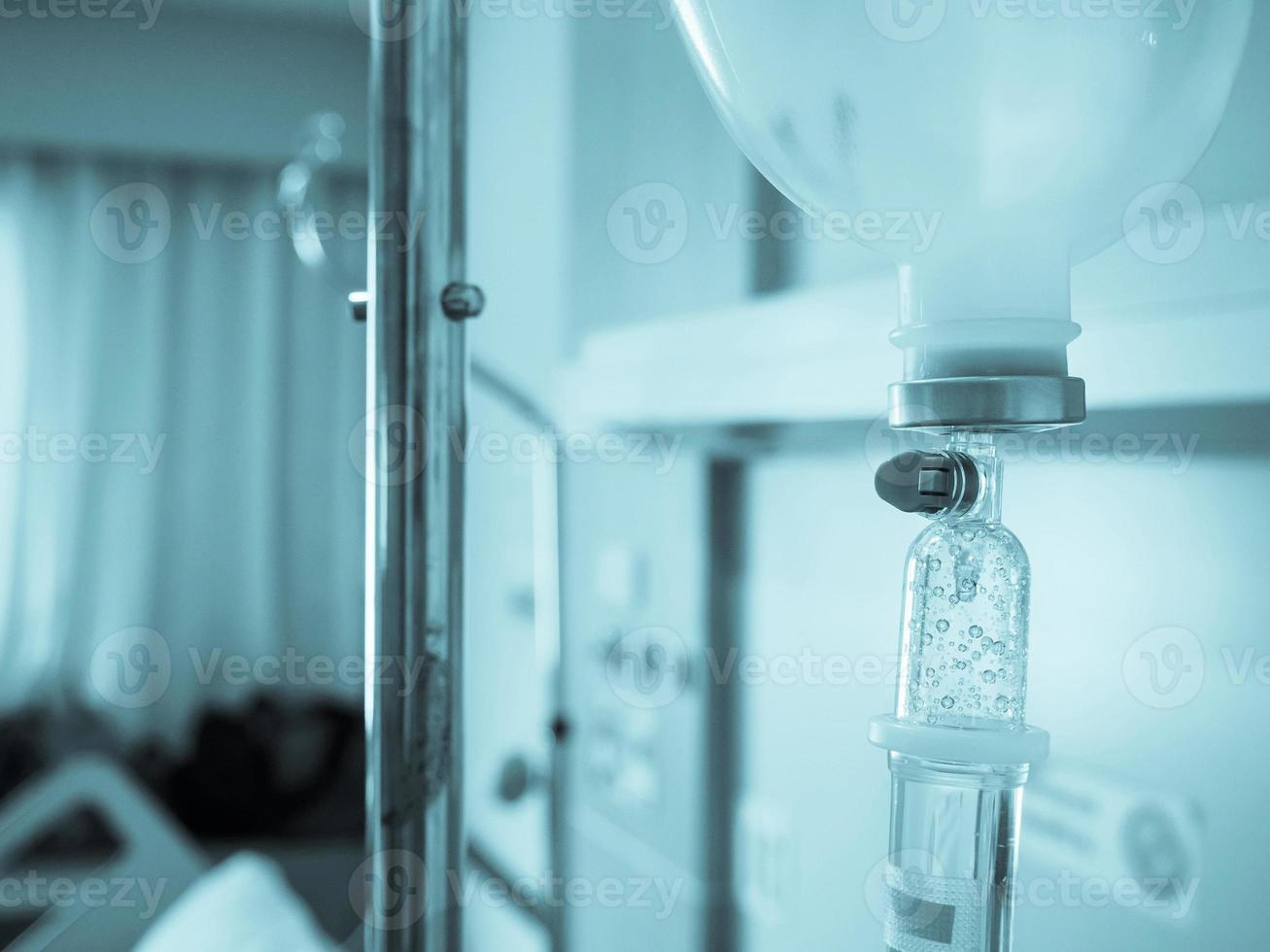 Medical drip with hospital blurred background photo