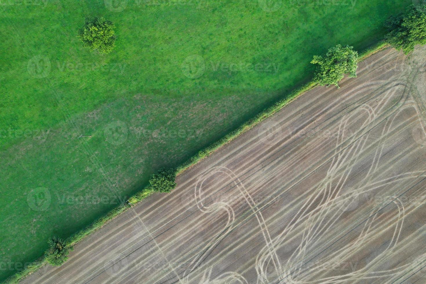 High angle view of cows grazing on field against sky. Gorgeous high angle aerial view of Animal Farm at British Agricultural Field Near London England Great Britain of UK photo
