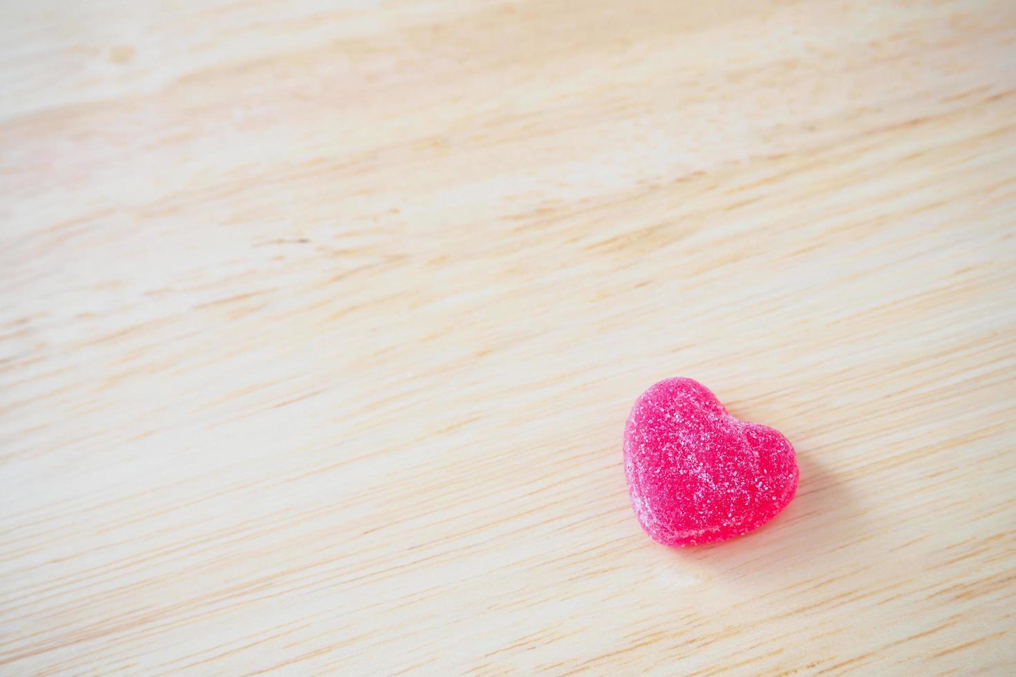 pink hearts candy on wood for valentines background photo