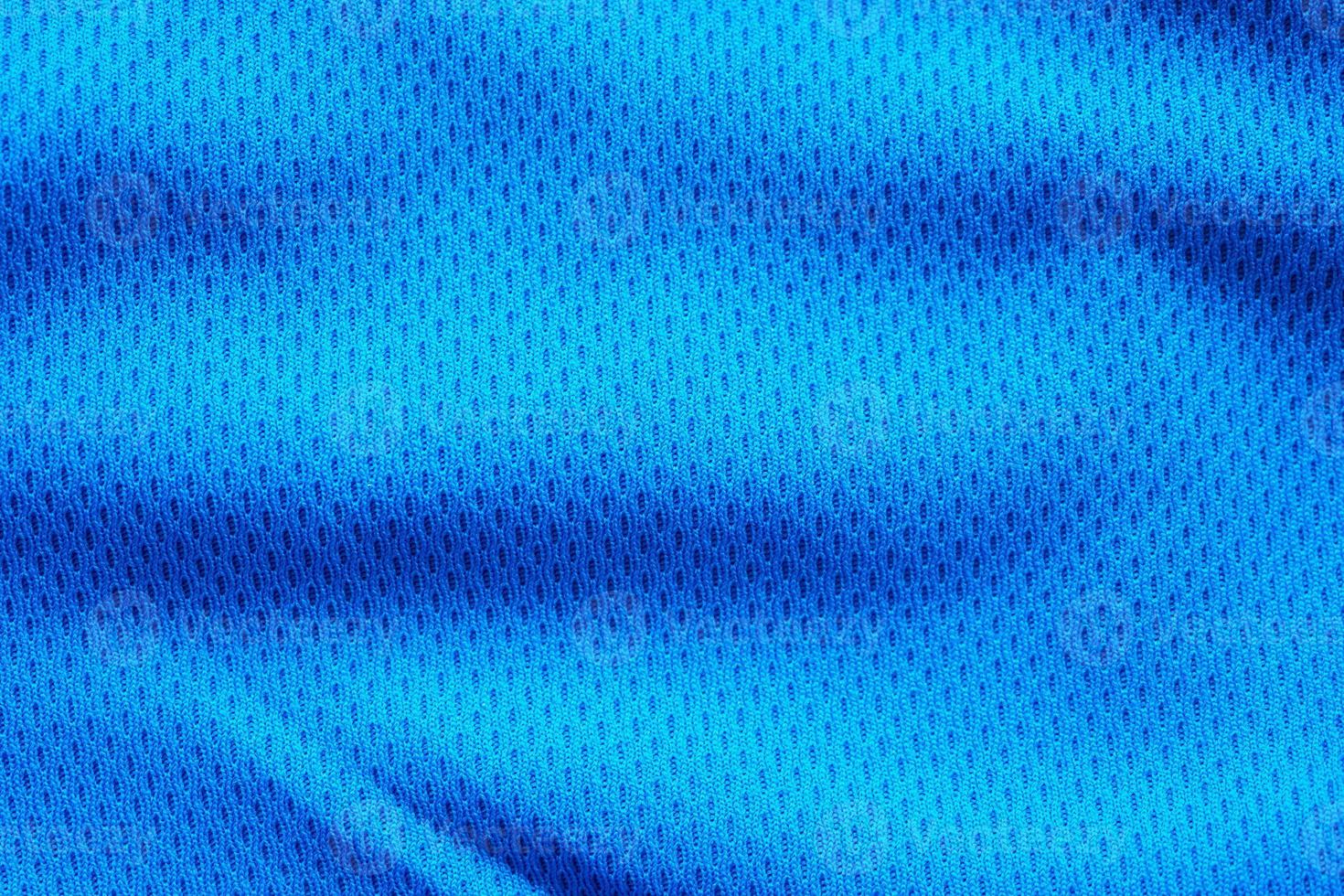 Blue fabric sport clothing football jersey with air mesh texture background photo