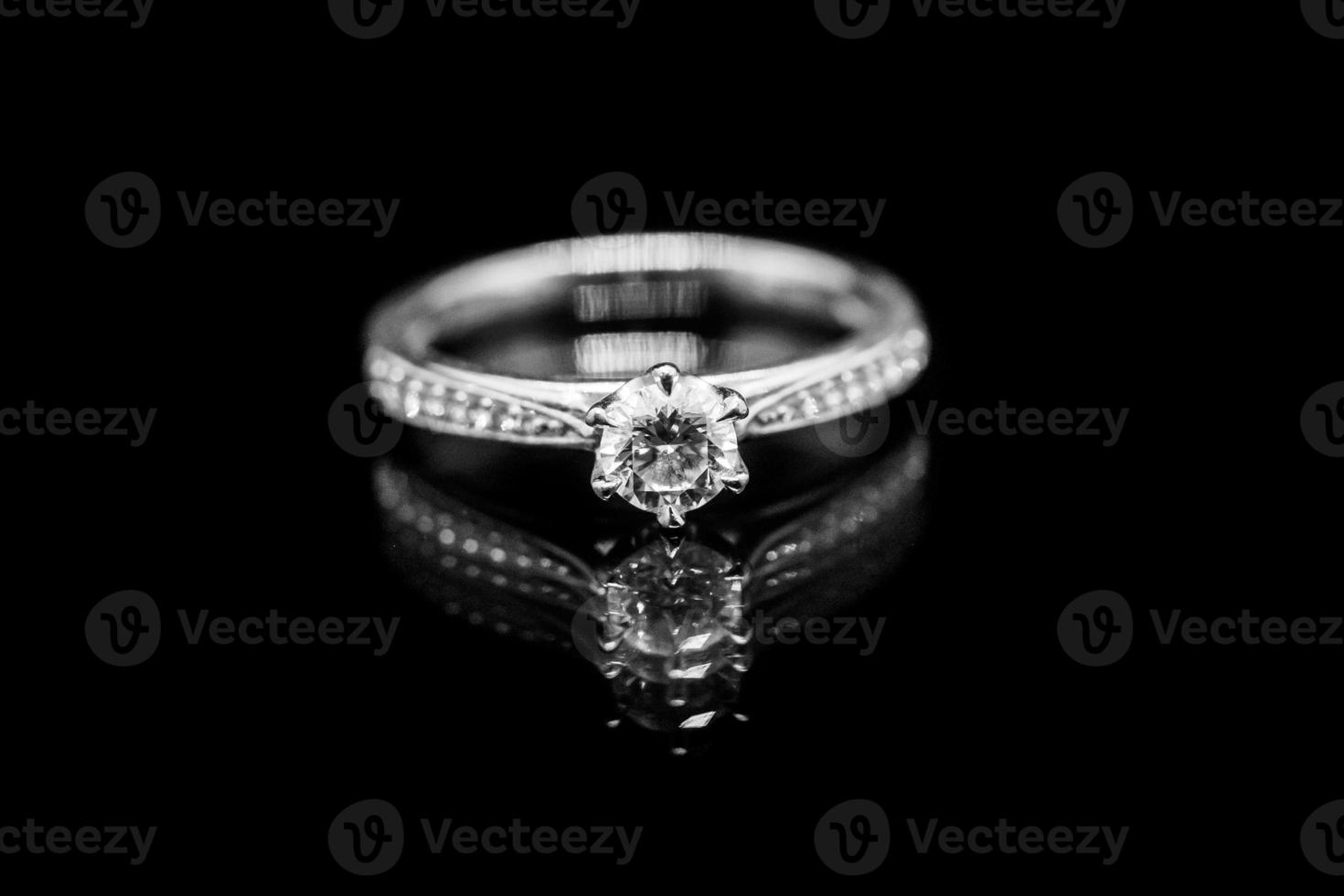 Close up Jewelry diamond ring on black background with reflection photo