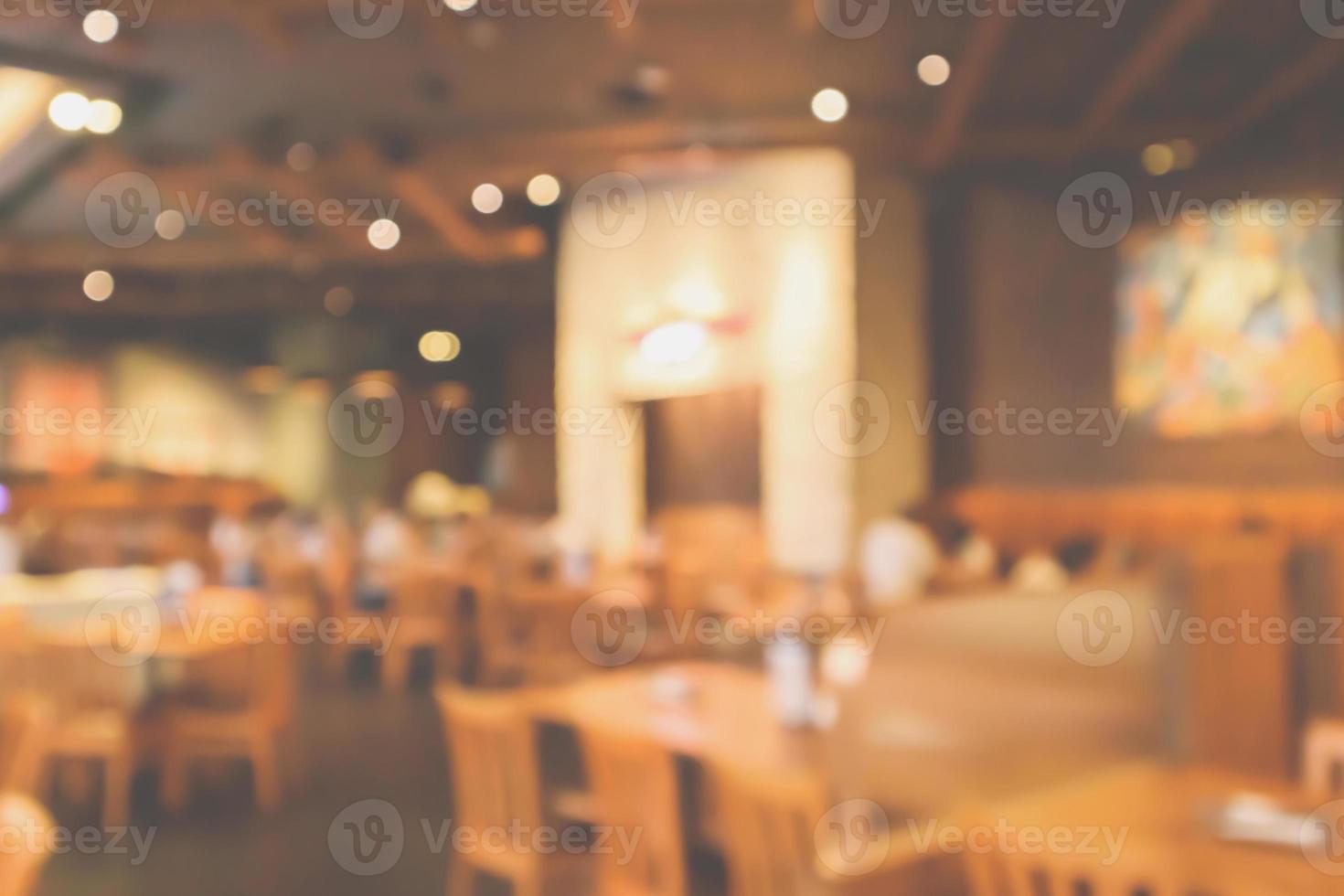 Restaurant interior with customer and wood table blur abstract background with bokeh light photo