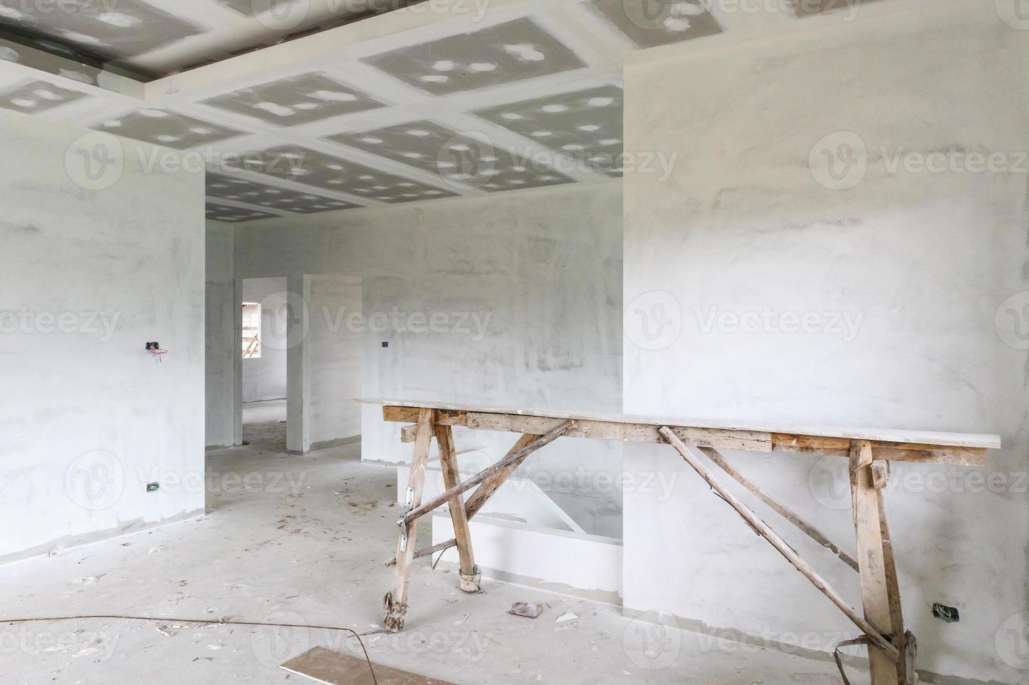 Empty room interior with gypsum board ceiling at construction site photo