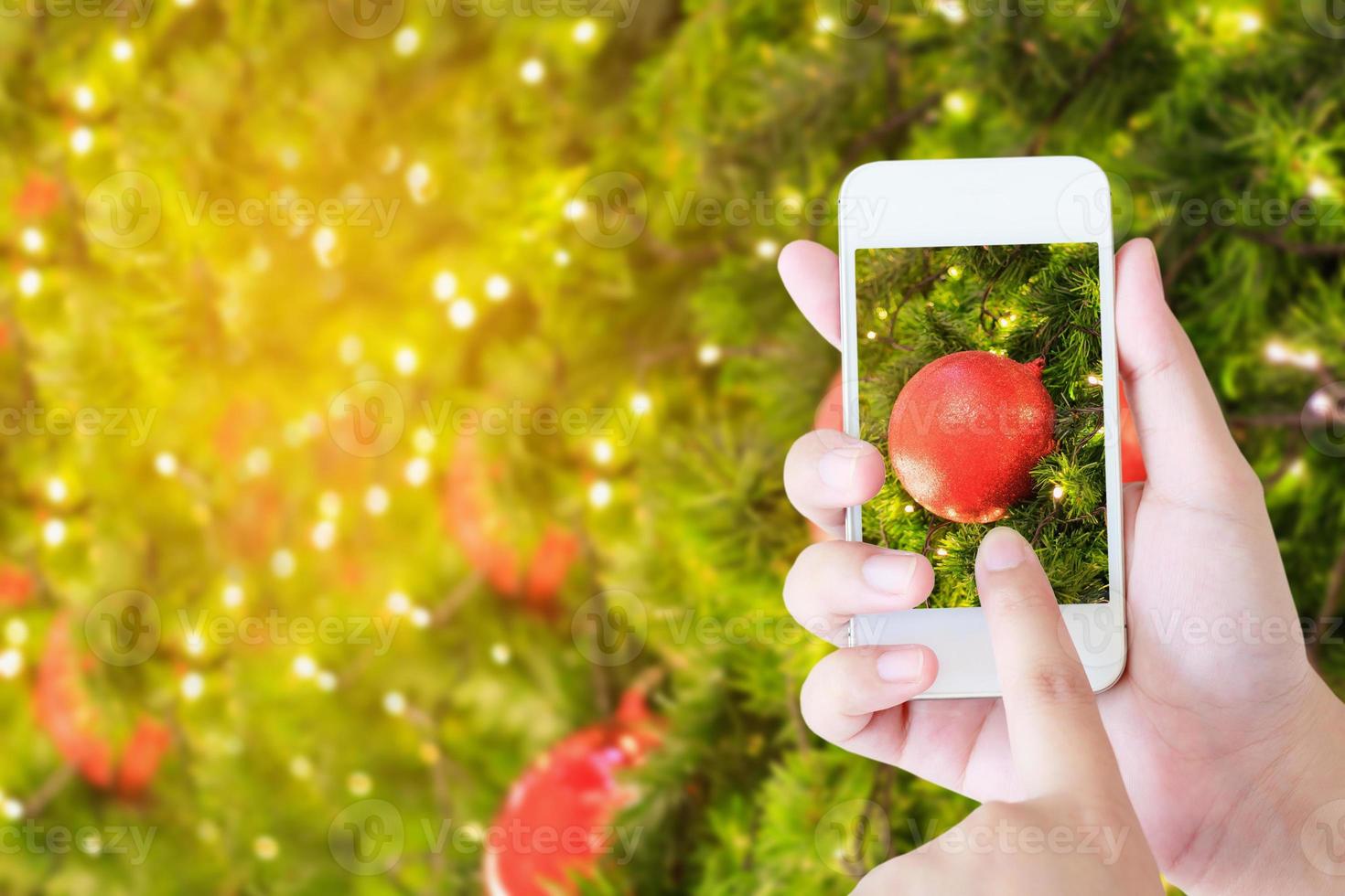 Woman taking picture of christmas decorations photo