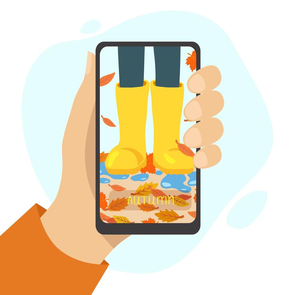 Hand holding phone with yellow rubber boots and falling leaves on the screen. Vector illustration, flat style