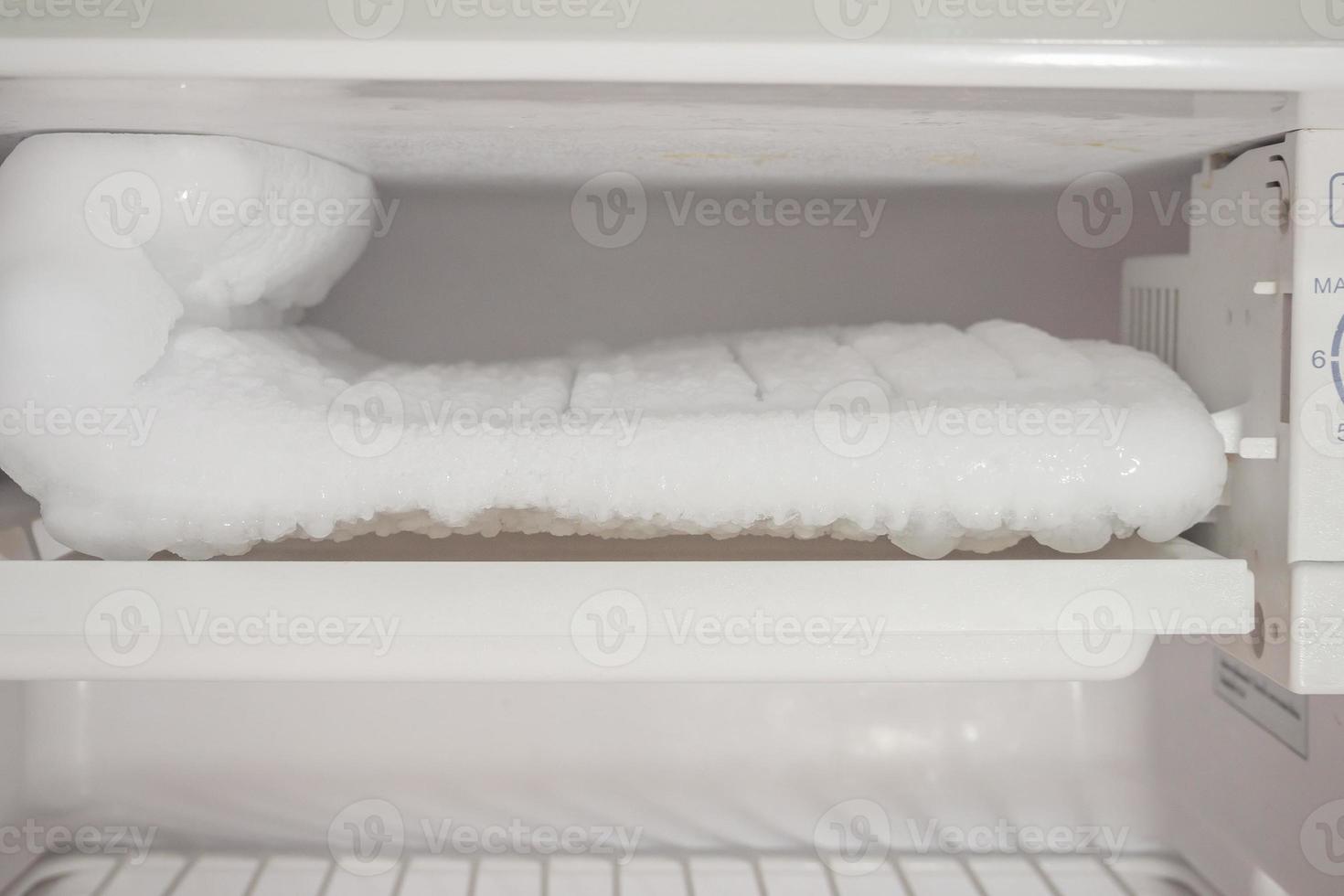 frozen Ice buildup in the freezer of refrigerator photo