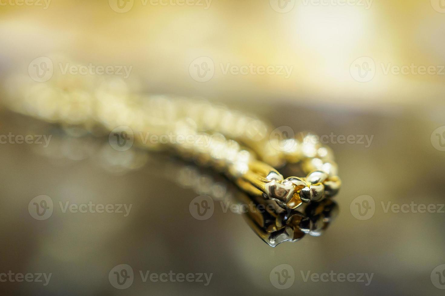 Luxury gold Jewelry bracelet with reflection on black background photo