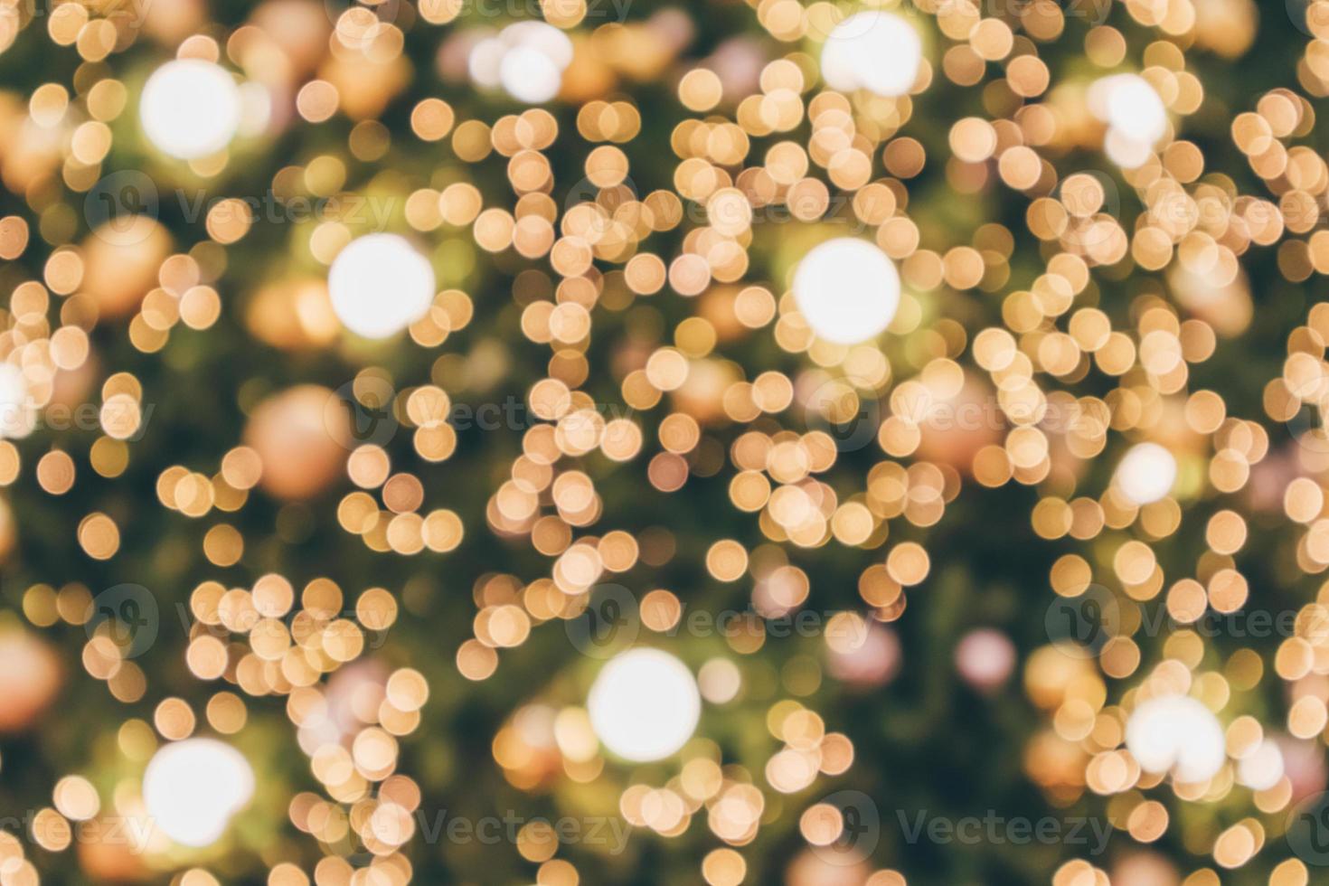 Abstract christmas holiday with festive gold bokeh light on tree blurred background photo