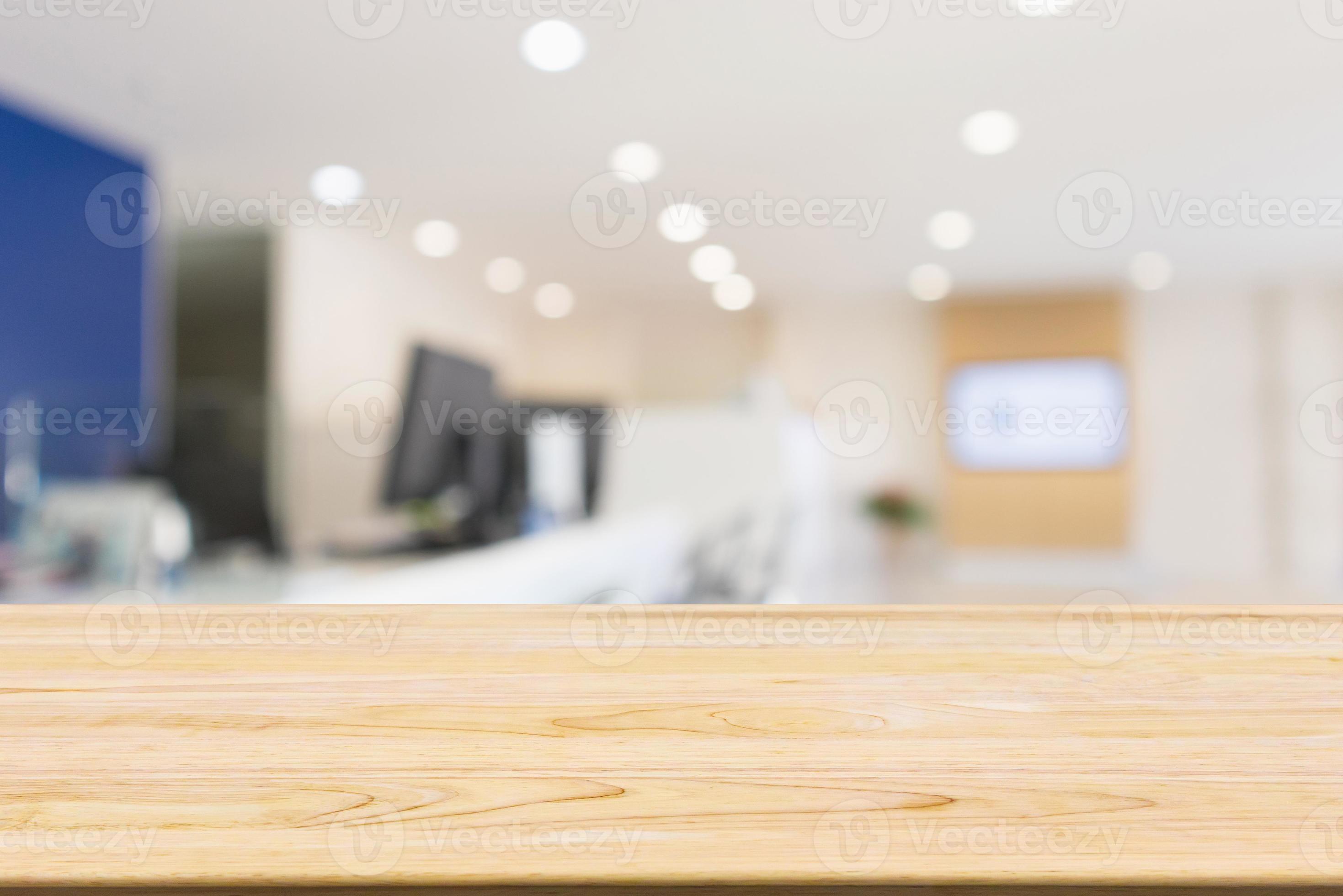 Wood table with Abstract blur office desk workplace with computer
