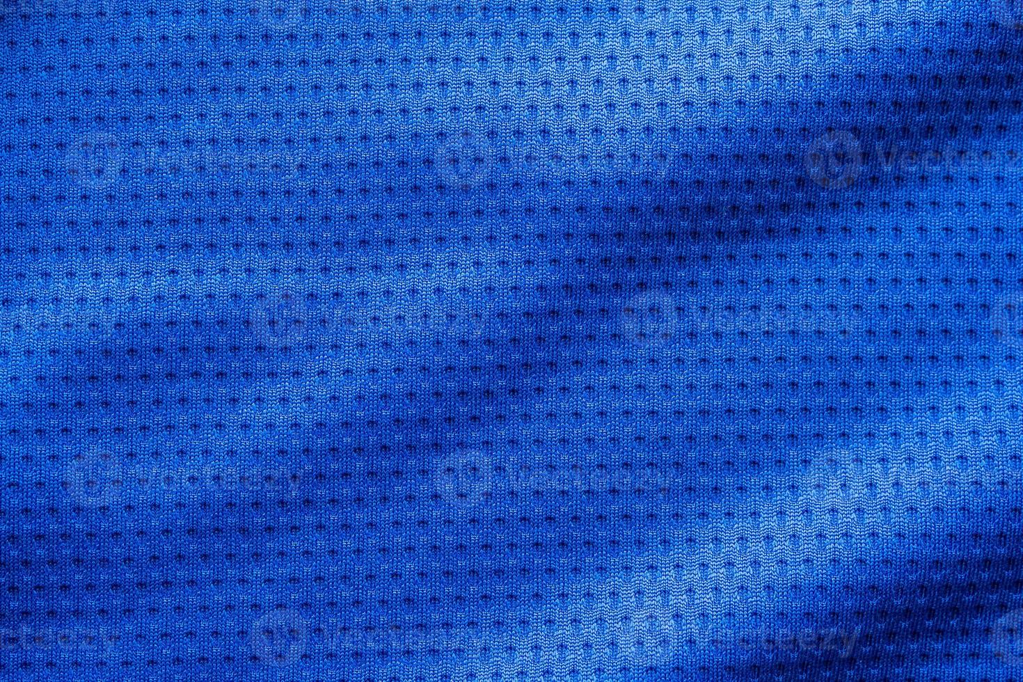 Blue color fabric sport clothing football jersey with air mesh texture background photo