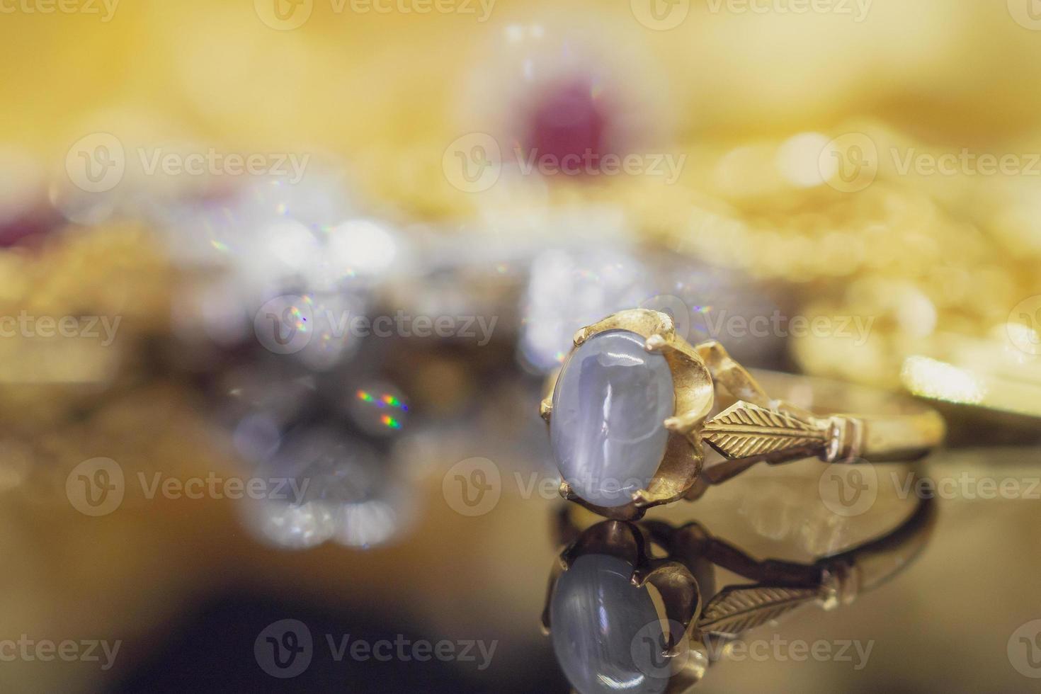 Vintage gold Jewelry blue sapphire rings with reflection on black background photo