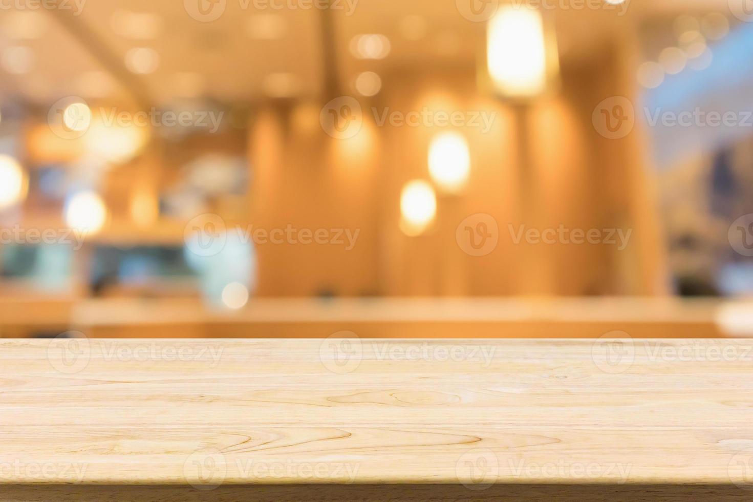 wood table with abstract blurred cafe restaurant with bokeh lights defocused background photo